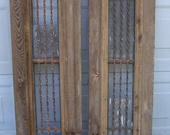 antique pediment windows with iron panels;salvage windows,wood windows,hand carved window panels,architectural windows,decorative wall art