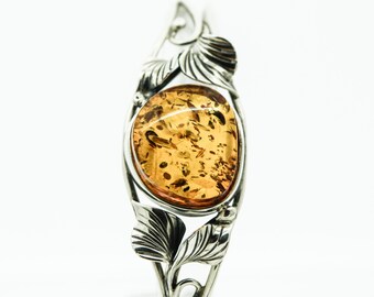 A Silver Amber Bangle With Decorated With A Leaf Design SKU425
