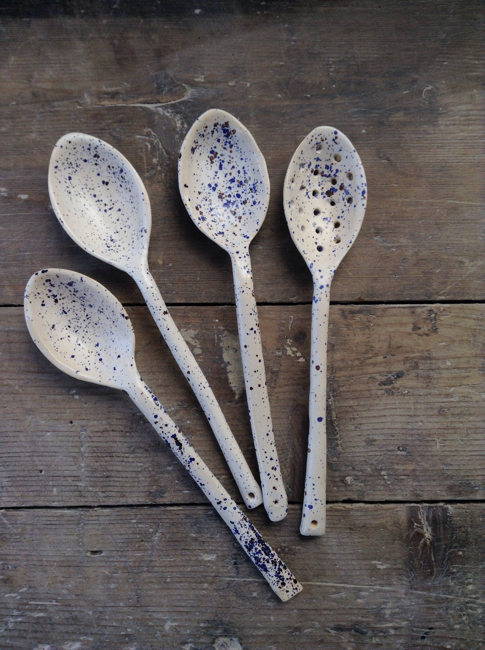 Handmade ceramic spoon. White with blue & brown speckles.