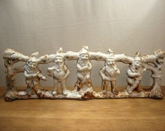 Vintage cast iron row of gnomes and trees