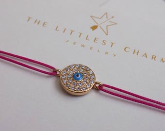 Evil eye bracelet with cubic zirconia on string. Delicate bracelet with cubic zirconia for protection and everyday use.