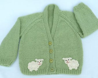 Baby sweater. Hand knitted pale green baby cardigan to fit a 6 to 12 months baby. Baby clothes, baby gift, baby shower.