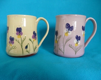 Handmade pottery mug Viola mugs in pale yellow and lilac with an apple green interior