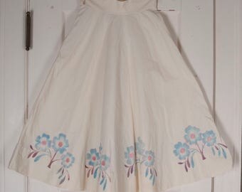1940s or white circle skirt w/ painted blossoms. Playful, classic, blue, pink, purple. Jitterbug, swing dance