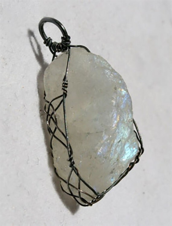 Rough rainbow moonstone pendant wrapped Celtic style with oxidized silver