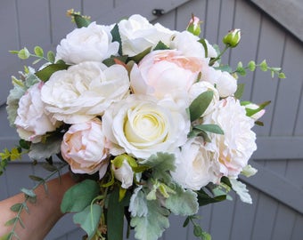 Ivory, white and blush pink silk wedding bouquet. Made with artificial roses, peonies, ranunculus, garden style roses and mixed greenery.