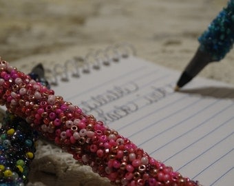Refillable beaded ink pens
