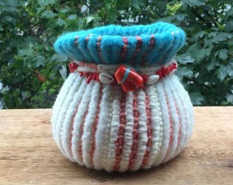 Hand knitted and felted around glass vase