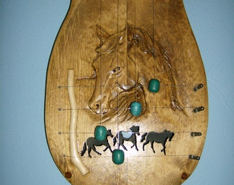 Carved horse head door harp