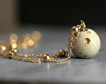 New: Concrete & Gold planet moon necklace. Delicate concrete full moon with crater landscape and satellite necklace. Dainty solar system.