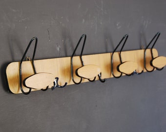 French vintage coat or hat rack in classic 70s design, double row of hooks , faux bois laminated finish on hardboard