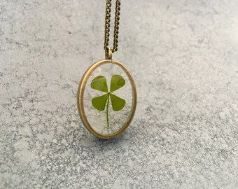 Four Leaf Clover in a dainty Oval Open-Back Antique Bronze Bezel Resin Necklace