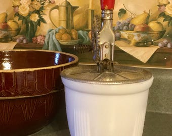 Metal hand Mixer with milk glass bowl made by A & J and stamped October 9, 1923