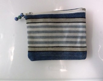 Coin purse in sturdy striped fabric. Lined, zippered, zipper pull of blue beads in lovely pattern. 6 1/4 x 5.5"