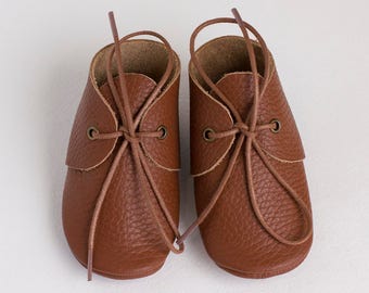Brown baby moccasins with shoe laces. Newborn, infant, toddler shoes