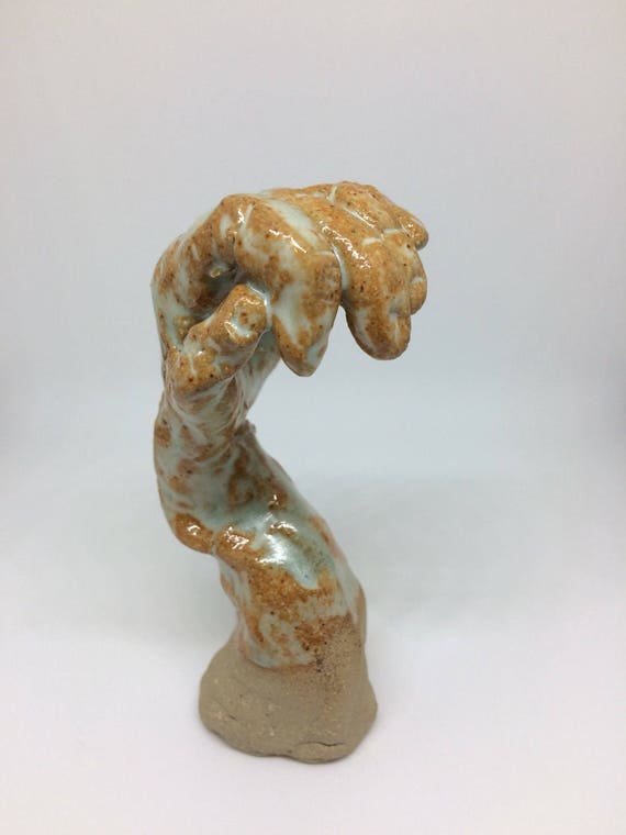 Strange and quirky ceramic hand sculpture