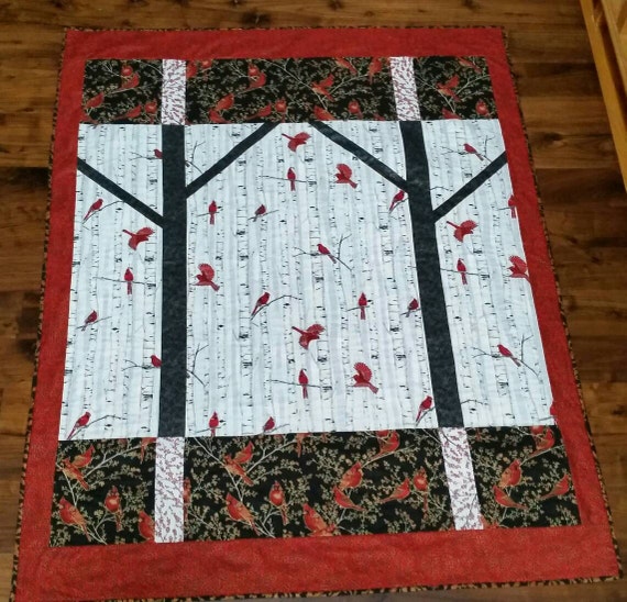 Lap quilt featuring cardinals in woodsy winter print w/ pieced