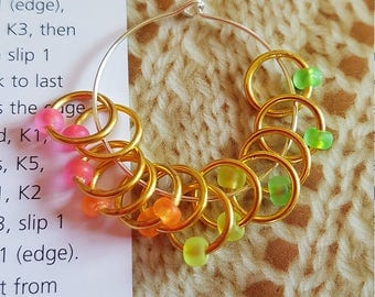 12 medium sized snag free ring style knitting stitch markers . Fluorescent gold