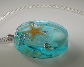Pendant with starfish, shells and silver leaf