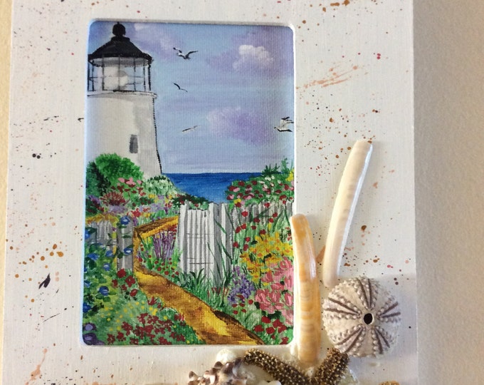 Framed acrylic lighthouse, decorated with seashells