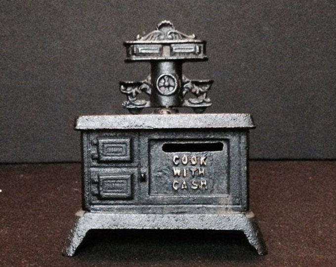 Storewide 25% Off SALE Vintage Primitive Style Black Cast Iron Stove Oven Coin Bank Featuring Catchy "Cook With Cash" Motto Advertising