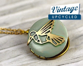 Small hummingbird locket necklace. Light bluegreen enameled locket with embedded hummingbird. Short golden brass necklace.