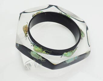Black faceted six sided lucite bracelet with real glowing insects