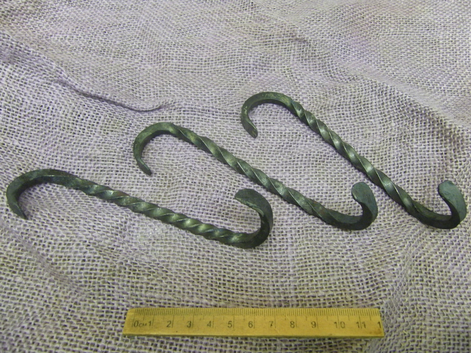 set of three wall mounted S hooks twisted through 90 degrees