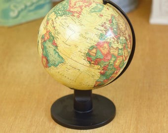 Small vintage globe, parchment colour on black stand