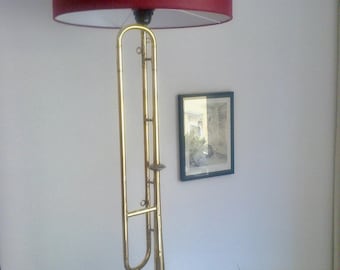 Table or floor lamp made from a natural trumpet.
