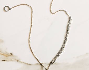 12in long layered metal chain necklace with rose quartz crystal pendant.
