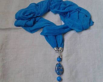 Blue scarf and his big gem bead