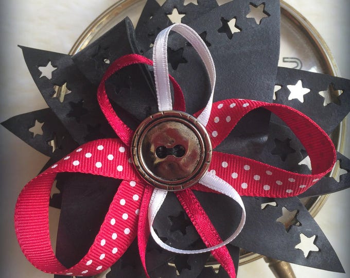 brooch in inner tube with large silver button and Ribbon colors red and white