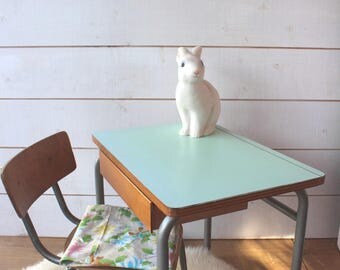 Small green formica school desk with water.
