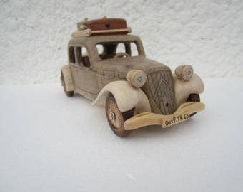 On the road. Wooden miniature of a Citroen traction before 11 CV car