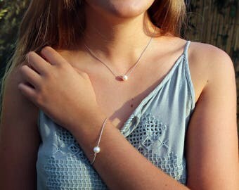 Lovely white freshwater cultured pearl bracelet made with a high quality sterling silver chain and a single faceted black spinel bead