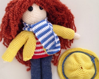 Red crochet doll in a yellow raincoat