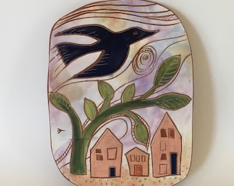 bird flying over houses hand carved ceramic art tile