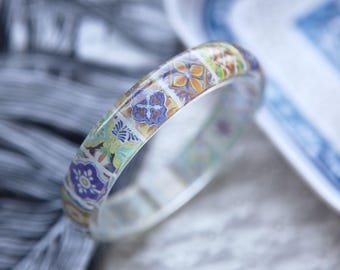 Resin bangle with embedded baroque style tile art