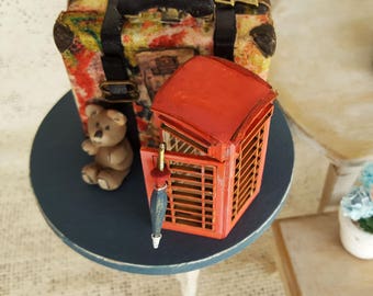 Miniature suitcase travelling from London and Paris