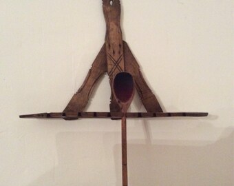 A naive 19th century wooden country spoon rack.