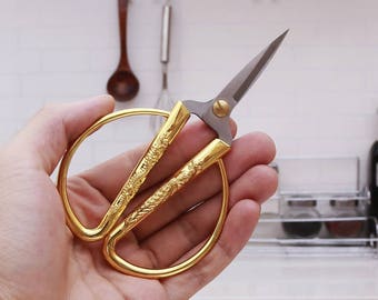 Vintage and retro style golden scissors with dragon and phoenix carve