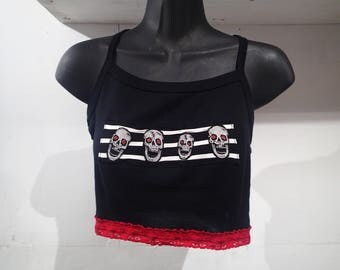 Black cropped top, stripes and skulls, red lace.