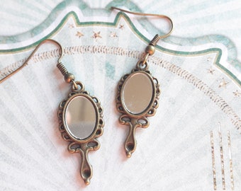 A pretty pair of earring mirror, vanity hand mirror