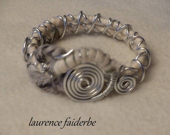 Bangle bracelet is made of aluminum and ecru wool and gray