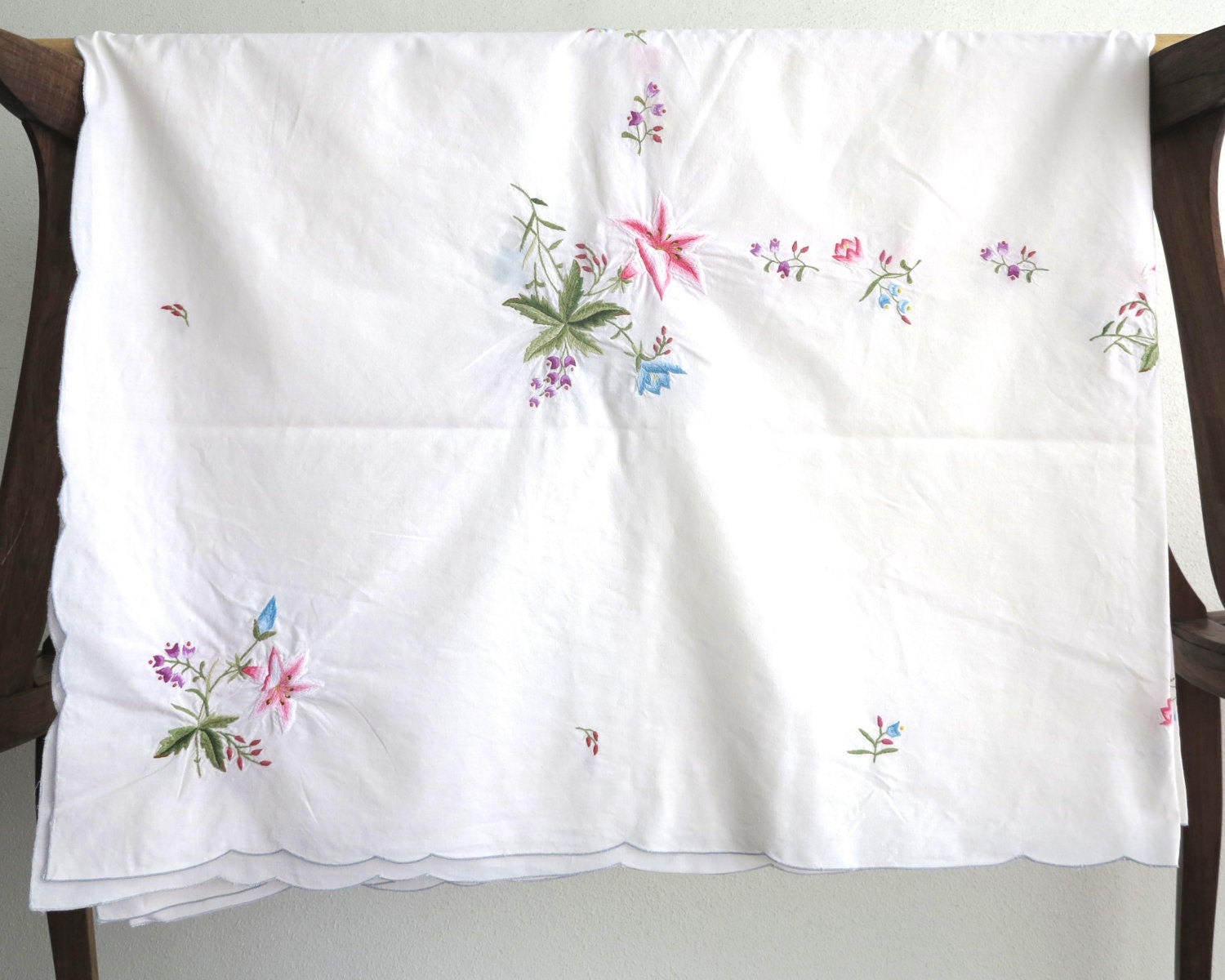 Embroidered tablecloth with bouquets of multi colored flowers
