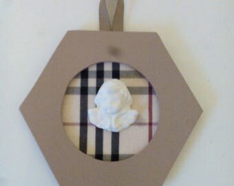 hexagonal medallion with a plaster Angel