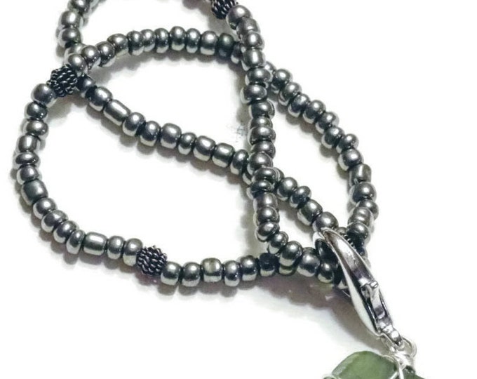 Beaded Bracelet - Rare Olive beach glass charm - gun metal gray beads - stretch bracelet - shiny - Pretty and Beachy
