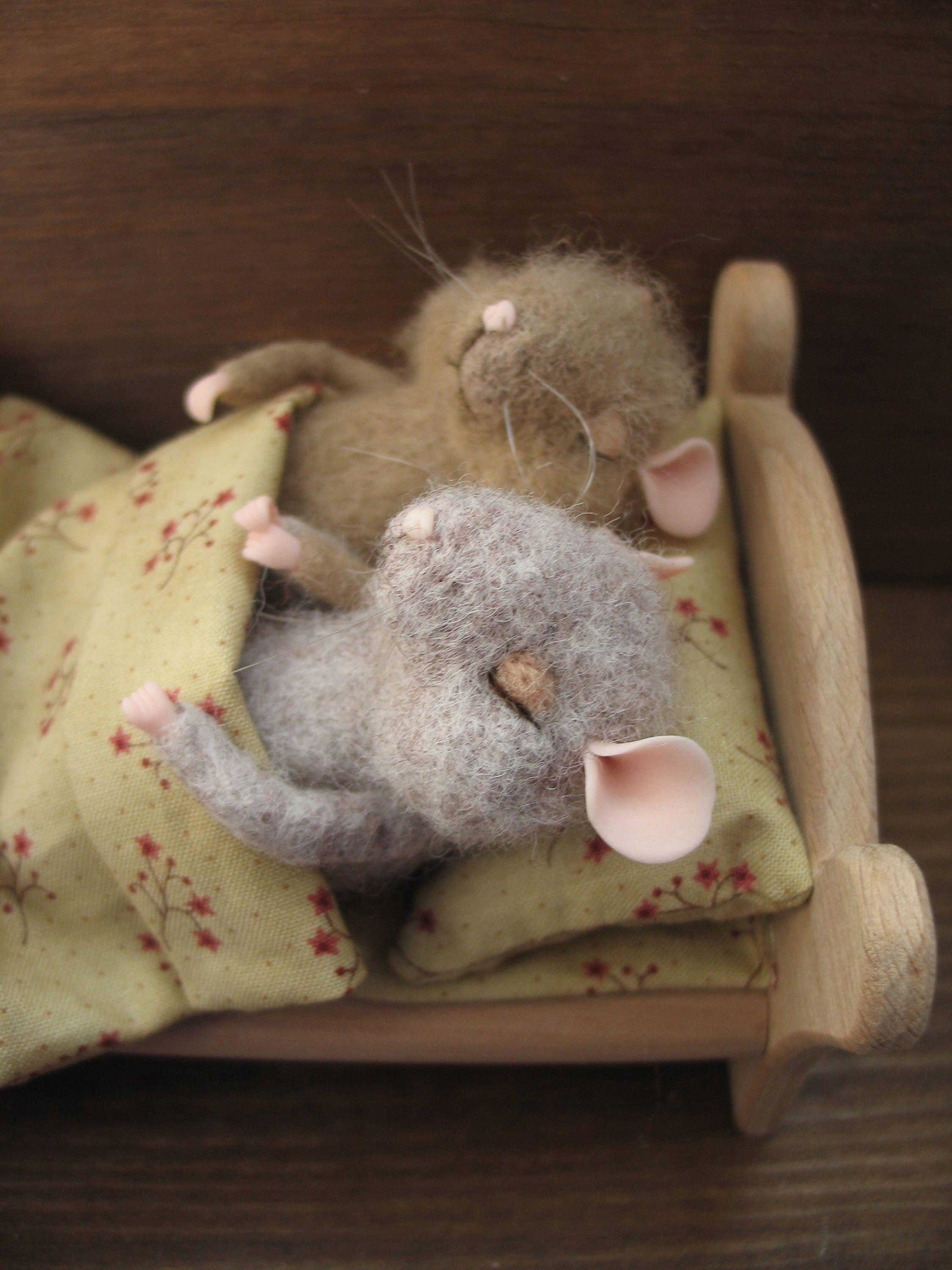 Little sleeping mice in a wooden bed with a needle felting