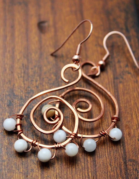 Hammered swirl copper wire earrings with white and cream glass
